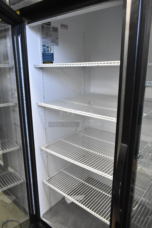 2019 True GDM-72-HC commercial 3 door reach-in cooler, 115V, 1 phase. Features glass doors, white wire shelves, and interior lighting.