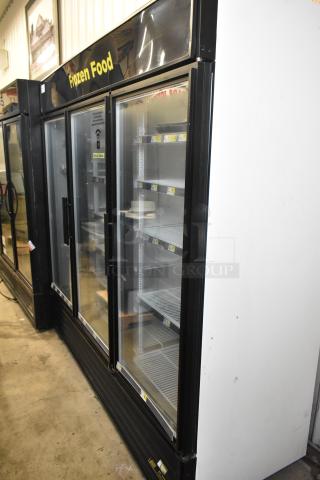 True GDM-72F-LD Commercial 3 Door Freezer, 115 Volts, black trim, clean shelves, "Frozen Food" label.