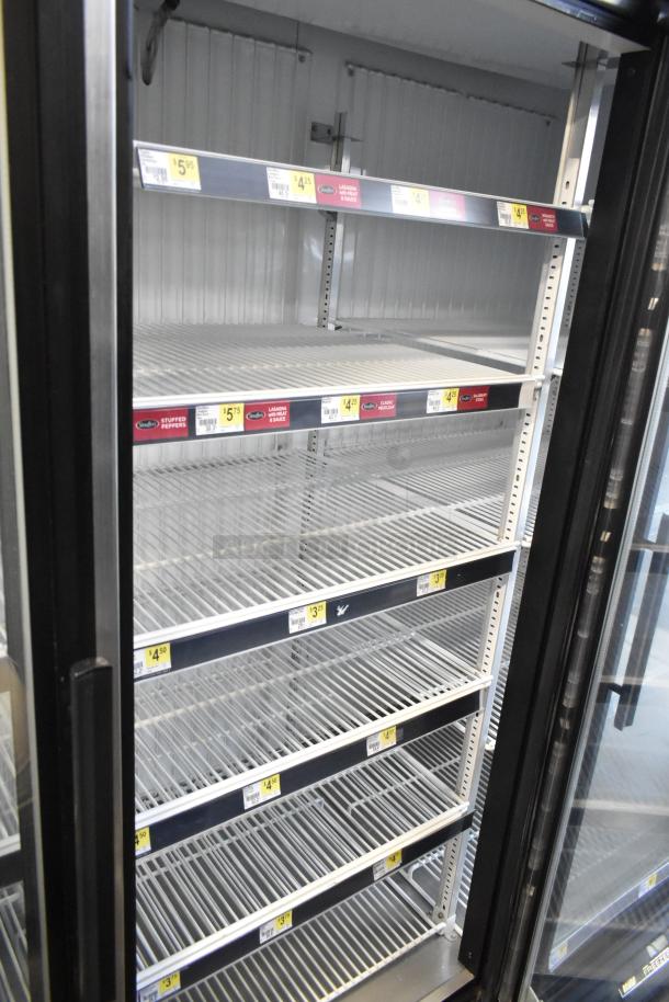 True GDM-72F-LD commercial 3-door freezer with glass front, multiple wire shelves. 115 volts, 1 phase power.