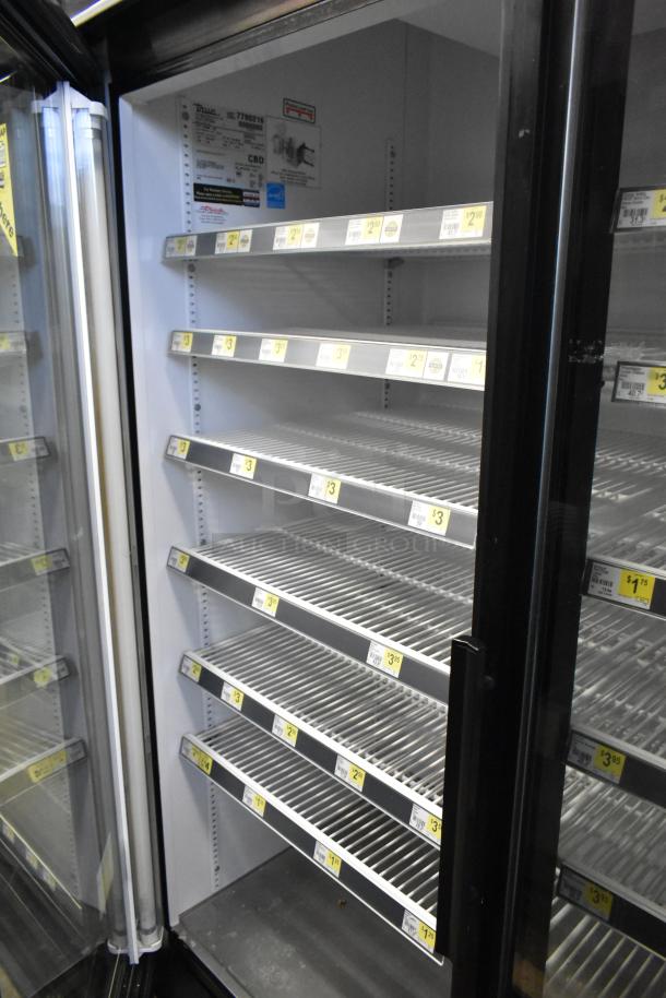 True GDM-49 Commercial 2 Door Reach In Cooler Merchandiser, features glass doors, shelving. Model details and price tags visible.