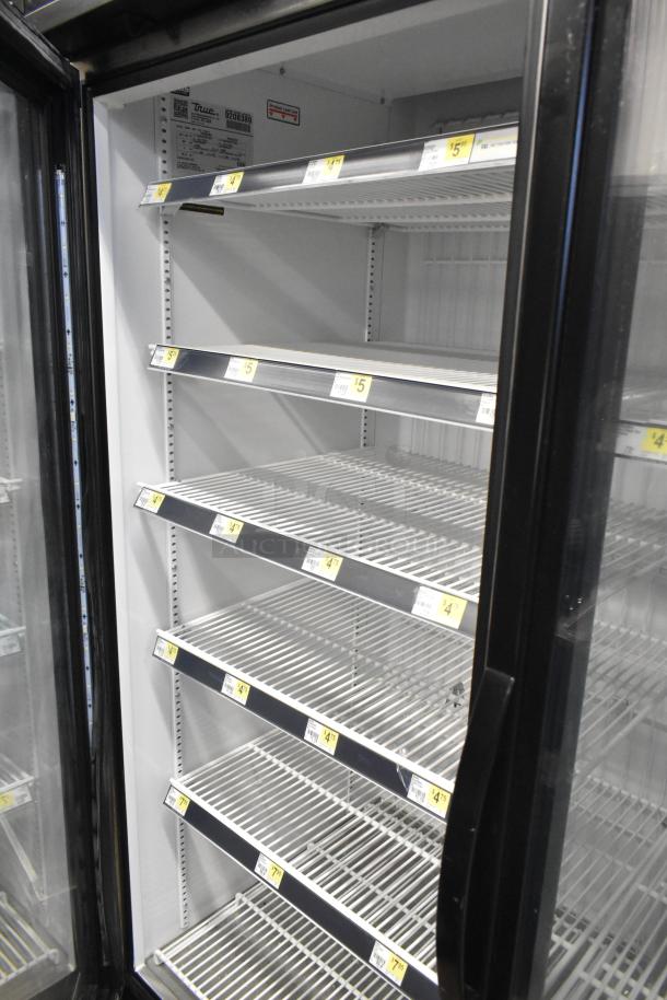 2017 True GDM-49F-HC commercial 2-door reach-in cooler, white interior, multiple shelves, model label visible, used condition.