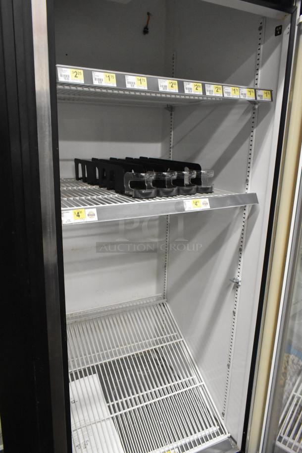 True GDM-72 Commercial 3 Door Cooler Merchandiser, 115V, 1 Phase, featuring adjustable shelves, clean interior.