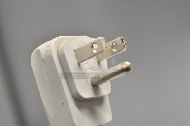 AHT RIO S 100 ice cream chest freezer plug close-up. Standard 115V plug, part of commercial merchandiser setup.