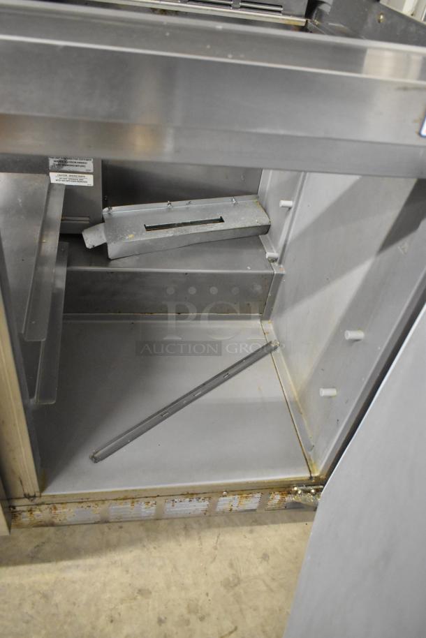 2019 Delfield 4472N-30M-TS11 prep table interior, showing metal components and slight cosmetic wear.