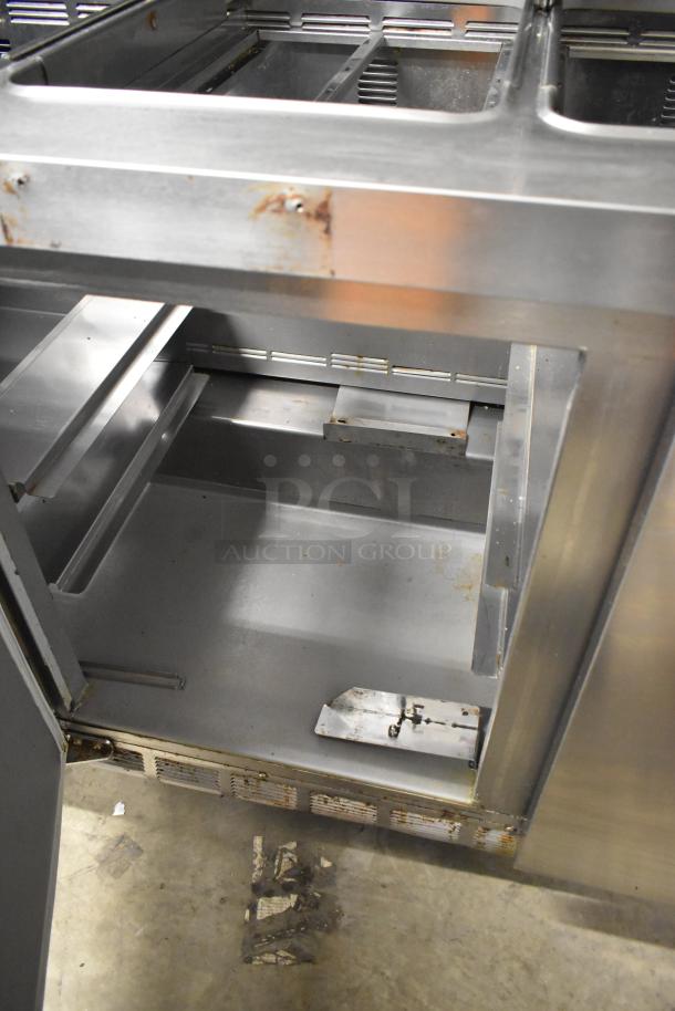 2019 Delfield 4472N-30M-TS11 sandwich salad prep table, stainless steel, visible wear, commercial casters, 115V, 1 phase.