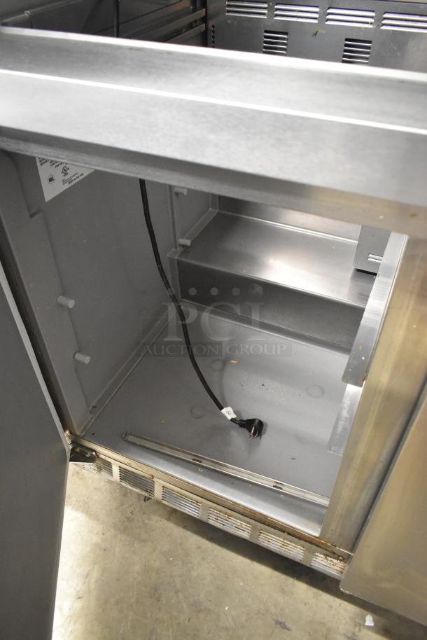 2019 Delfield 4472N-30M-TS11 sandwich salad prep table interior, shows clean surface, power cord, minor wear.