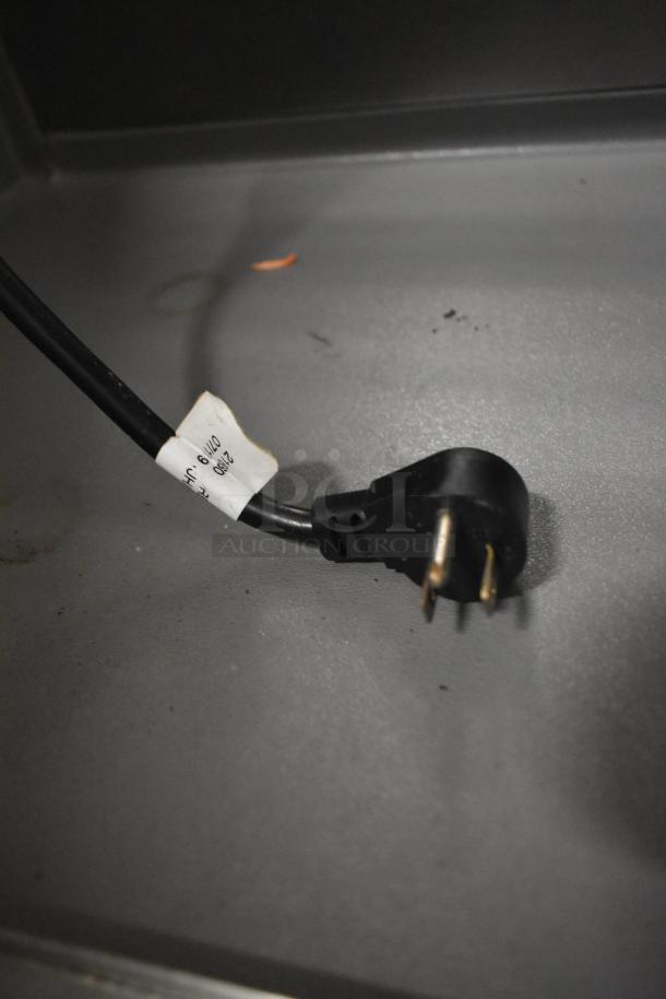 Close-up of a power cord plug with an attached label reading "2190 0119." Part of Delfield 4472N-30M-TS11 prep table.