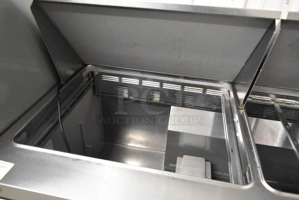 2019 Delfield 4472N-30M-TS11 commercial sandwich salad prep table. Stainless steel, bain marie top, on casters.