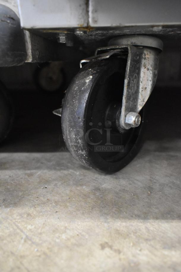 Beverage Air HR2-1S commercial cooler caster, showing wear. Durable metal and rubber construction, suitable for mobility.