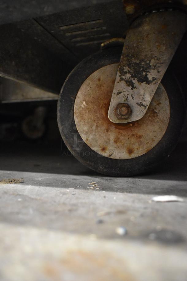 2016 Metro C519-CFC-U heated holding cabinet caster, showing moderate wear.