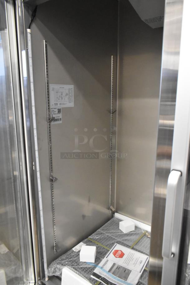 Brand new 2025 KoolMore RIR-2D-GD commercial cooler, 2-door, 115 volts, 1 phase, scratch and dent, interior shelving visible.