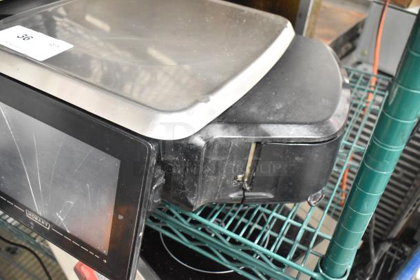 2017 Hobart HTi-7LH26 metal food portioning scale, black casing, no power cord, tested and working, visible label marked "36".