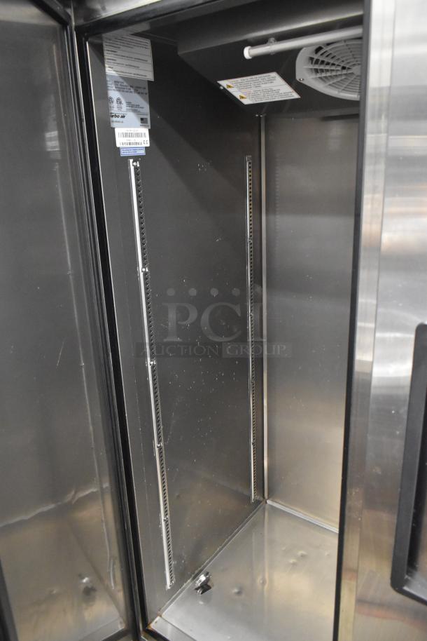 Turbo Air M3R47-2-N commercial two-door reach-in cooler, clean interior, shelves removed, on commercial casters.