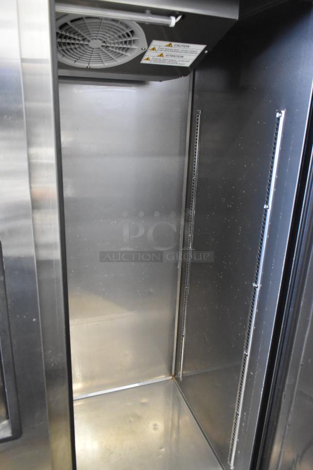 Turbo Air M3R47-2-N 2 Door Reach-In Cooler, stainless interior with ventilation and caution labels, on commercial casters.