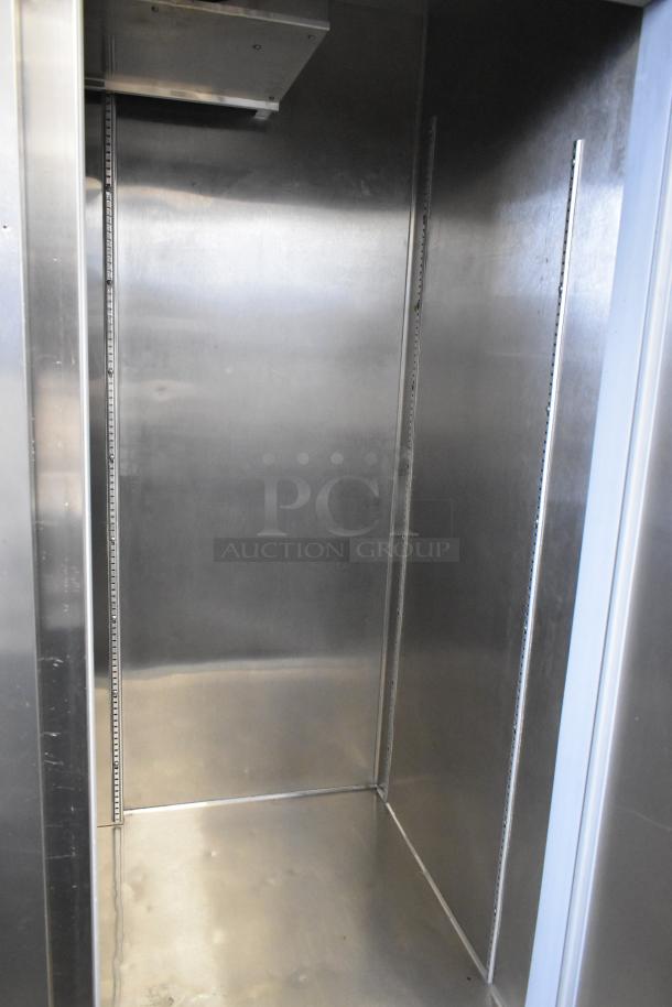 Beverage Air HBF49-1 commercial freezer interior, stainless steel, showing clean shelves and walls, on commercial casters.