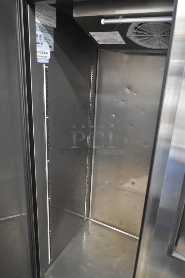 Turbo Air M3F47-2-N Commercial 2-Door Freezer interior, visible shelving tracks and minor dents. 115 Volts, 1 Phase.