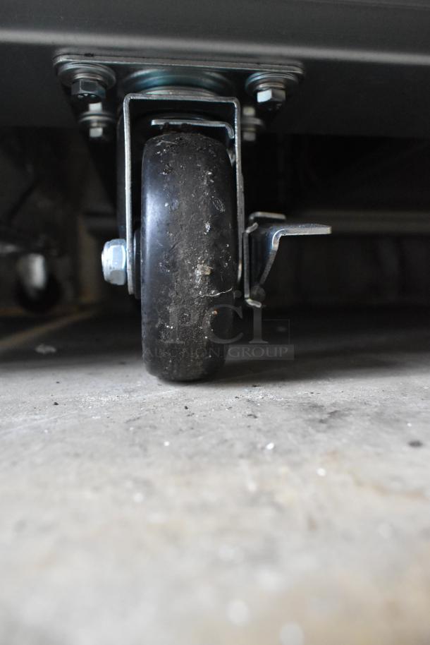 Avantco 178A49RHC cooler caster wheel detail, slightly worn. Suitable for commercial use, 115V, 1 Phase.