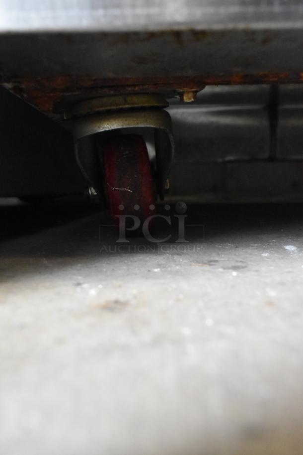 2021 COW800 Commercial Cooler caster; sturdy, supports 2-door reach-in unit; moderate wear visible, suitable for 115V outlets.