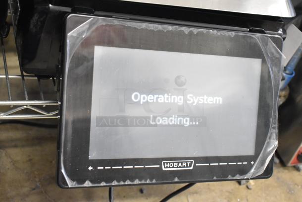 Hobart HTi-7LH4W food portioning scale with operating system loading screen. Tested and working.