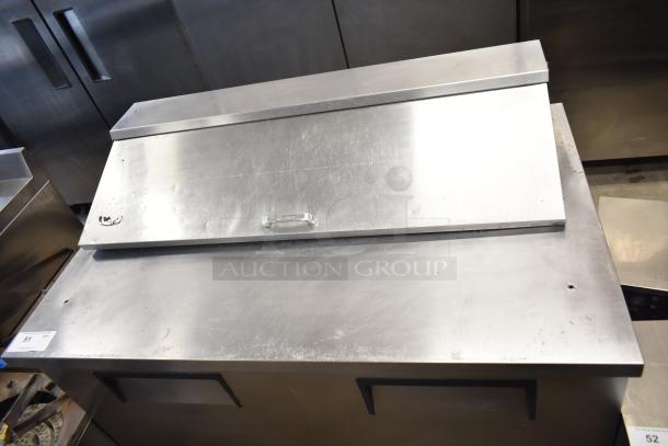 True TSSU-48-12 commercial sandwich salad prep table, stainless steel, visible wear, on commercial casters, 115V, 1 phase.