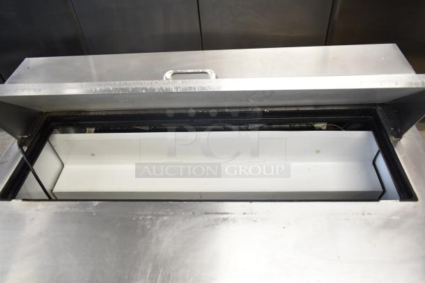 True TSSU-48-12 commercial sandwich salad prep table, stainless steel surface, open lid, on casters, 115V, 1 phase.