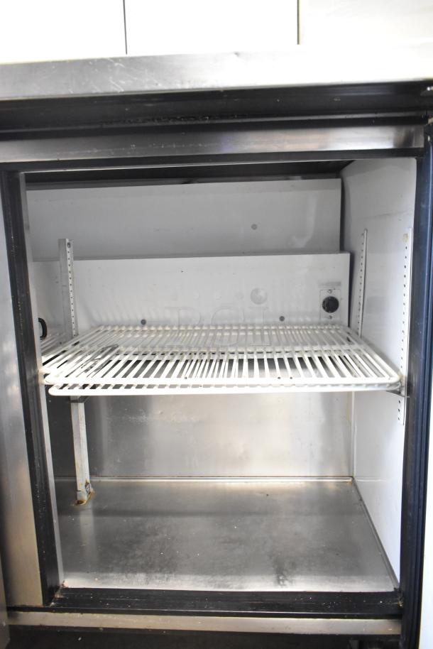 True TSSU-48-12 commercial sandwich salad prep table on casters, interior view. Good condition, 115 volts, 1 phase.