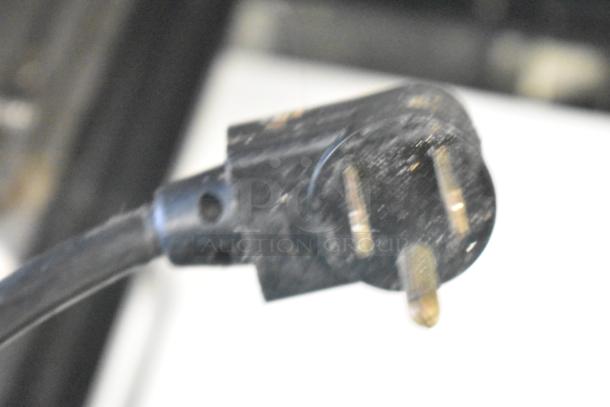 True TSSU-48-12 Commercial Prep Table, 115V, with casters. Close-up of power plug.