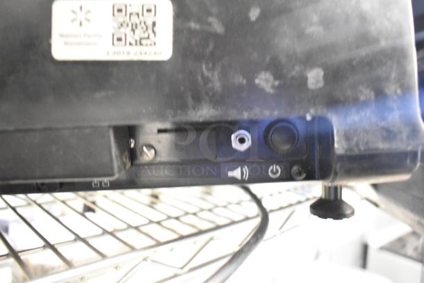 2017 Hobart HTi-7LH26 food portioning scale, tested and working, features power and audio controls. Plugged in on metal shelf.