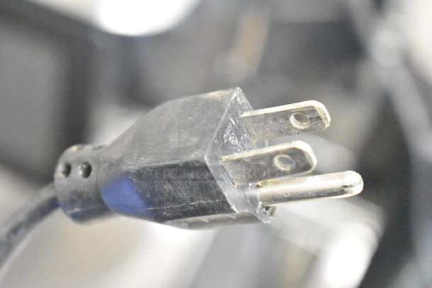 Close-up of the plug for a Hobart HTi-7LH26 commercial food portioning scale. Black, three-prong design.