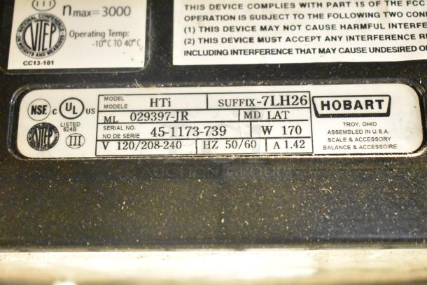Close-up of label on 2017 Hobart HTi-7LH26 scale, showing model number, voltage, and certification marks. No power cord included.