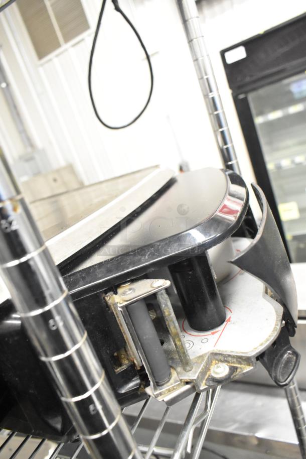 2017 Hobart HTi-7LH26 metal food portioning scale on shelf, missing power cord, tested and working.