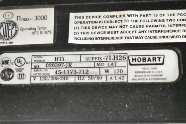 2017 Hobart HTi-7LH26 food portioning scale label, showing model and voltage details. No power cord included.