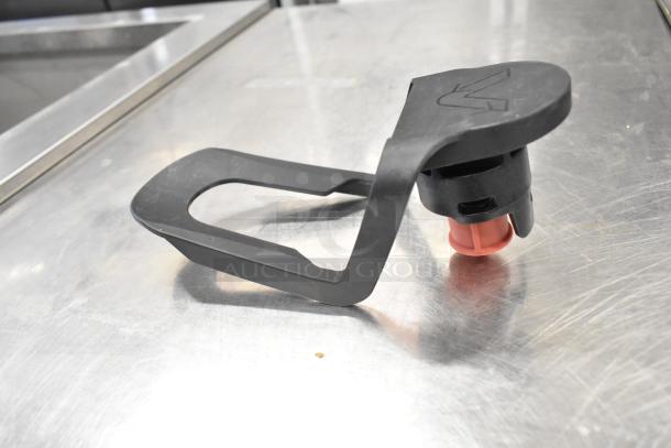 Black plastic spigot handle with a red nozzle for Narvon 378RBD5G3 beverage dispenser, resting on a metal surface.