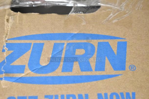 Cardboard box with blue Zurn logo, indicating packaging for Zurn Z1996-24 Mop Basin Grey. Box appears slightly damaged.