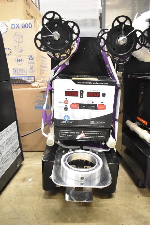 Autata ATT-95N automatic plastic cup sealing machine, 115V, 1 phase, shows temperature and counter displays, model label visible.