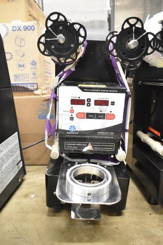 Autata ATT-95N automatic plastic cup sealing machine, 115V, 1 phase, shows temperature and counter displays, model label visible.