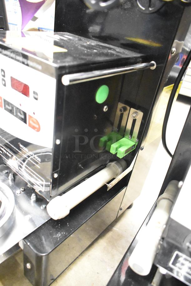 Autata ATT-95N automatic plastic cup sealing machine, black, 115V, 1 phase. Features control panel and green buttons.