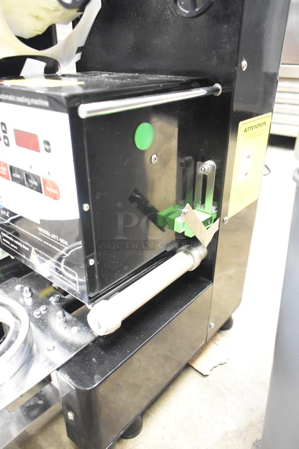 Autata ATT-95N automatic plastic cup sealing machine, 115 volts, black exterior, visible control panel, model label.