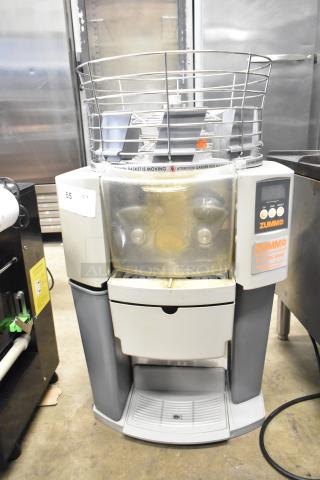 Zummo Z14C commercial citrus juicer, countertop model, 110 volts, 1 phase. Features safety cage, visible control panel, fair condition.
