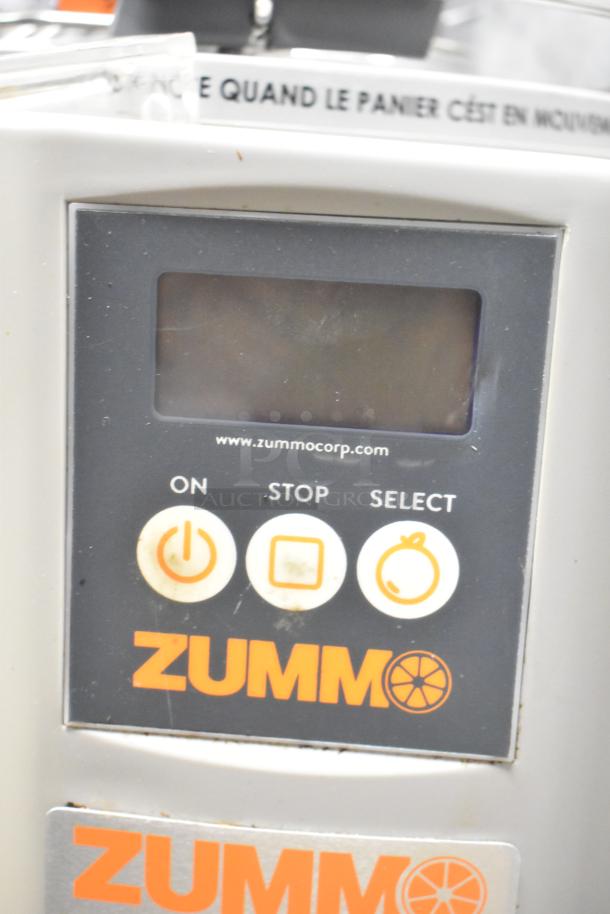 Zummo Z14C commercial citrus juicer control panel, featuring power, stop, and select buttons. Visible wear indicates use.