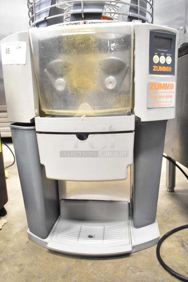 Zummo Z14C commercial citrus juicer, countertop model, in used condition. Features include 110 volts, 1 phase power. Labels visible.