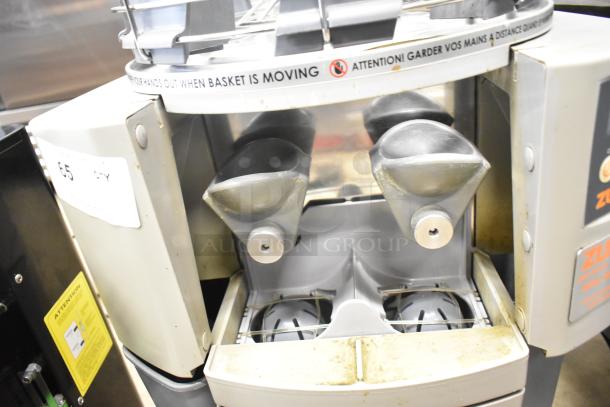 Zummo Z14C Commercial Citrus Juicer, countertop model, dual spouts, visible wear, tags with safety instructions, 110V, 1 phase.