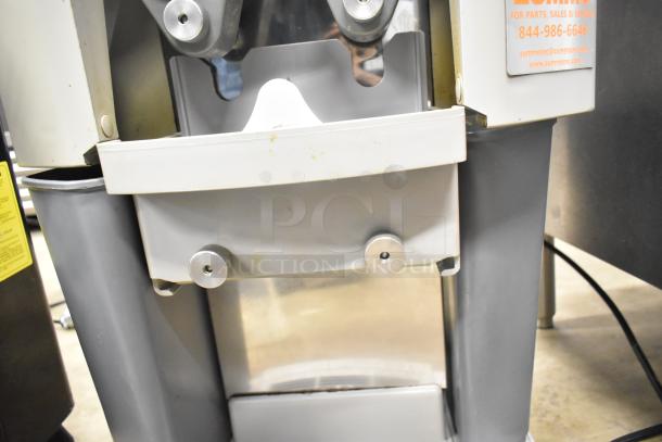 Zummo Z14C commercial countertop citrus juicer, used. Visible wear on gray frame. Model label includes contact info.