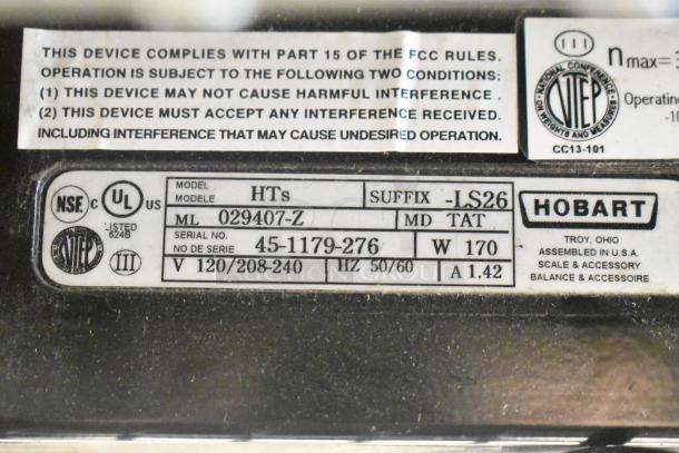 2017 Hobart HTs-LS26 metal commercial scale label, showing model number, voltage (120/208-240V), and certification marks.