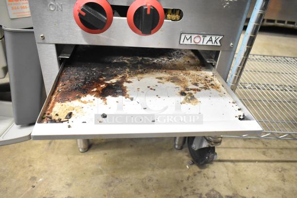 Motak commercial countertop gas-powered single burner stock pot range with visible usage marks and grease stains, durable construction.