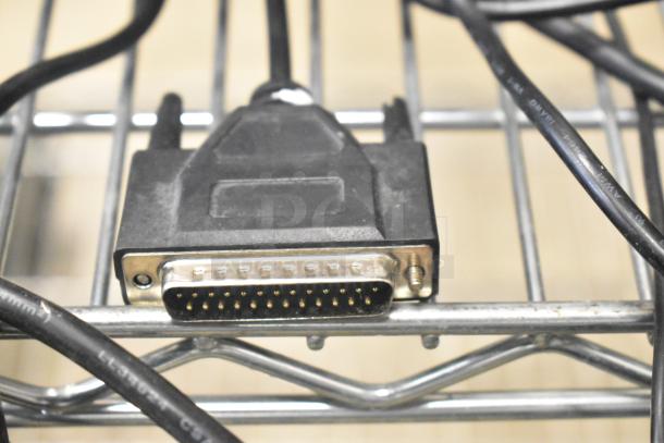 Close-up image of a DB-25 connector with attached cable, part of auction lot including 2 cash drawers and 5 POS monitors.