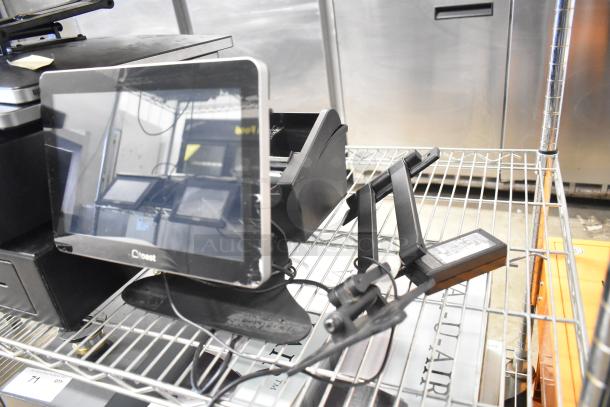 10 various items including 2 cash drawers and 5 POS monitors on a metal shelf, used condition.