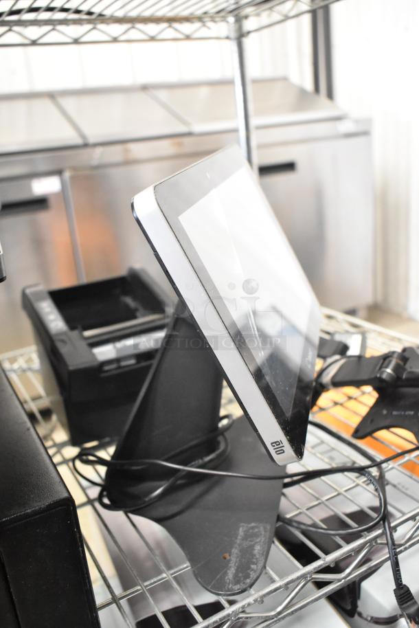 10 various items including 5 Elo POS monitors and 2 cash drawers. Monitors have sturdy black stands. Used condition.