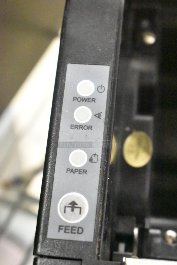 Close-up of control panel on a cash drawer with buttons labeled Power, Error, Paper, and Feed.