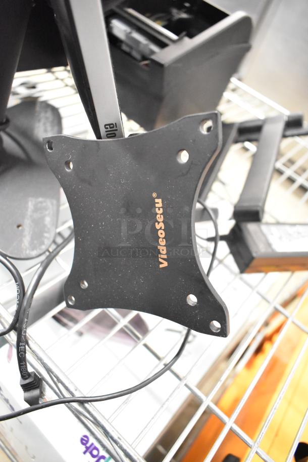 10 various items including VideoSecu VESA mount, Elo POS monitor, and cash drawers on wire rack. Industrial use.